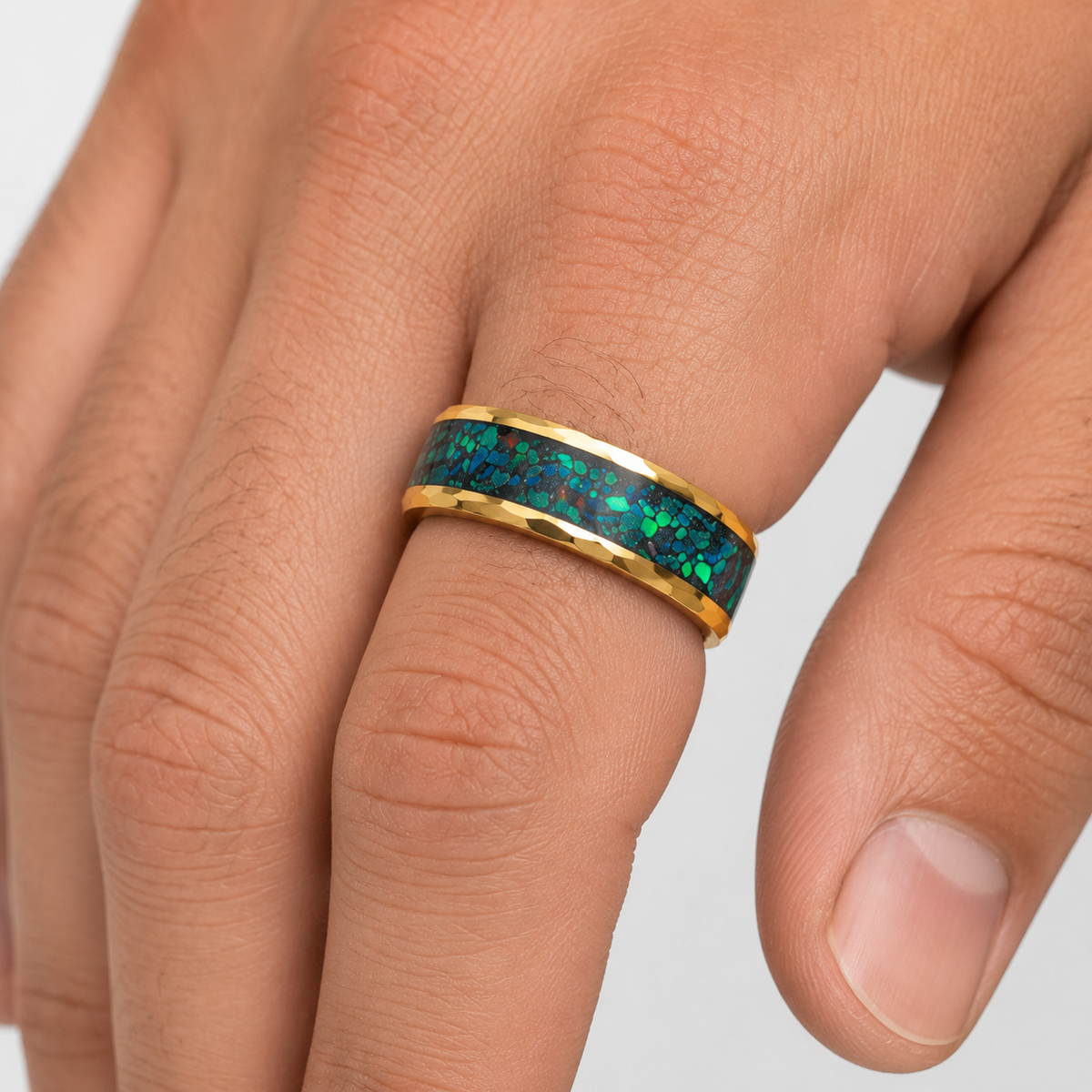 Gold men's wedding band with blue green opal worn on hand