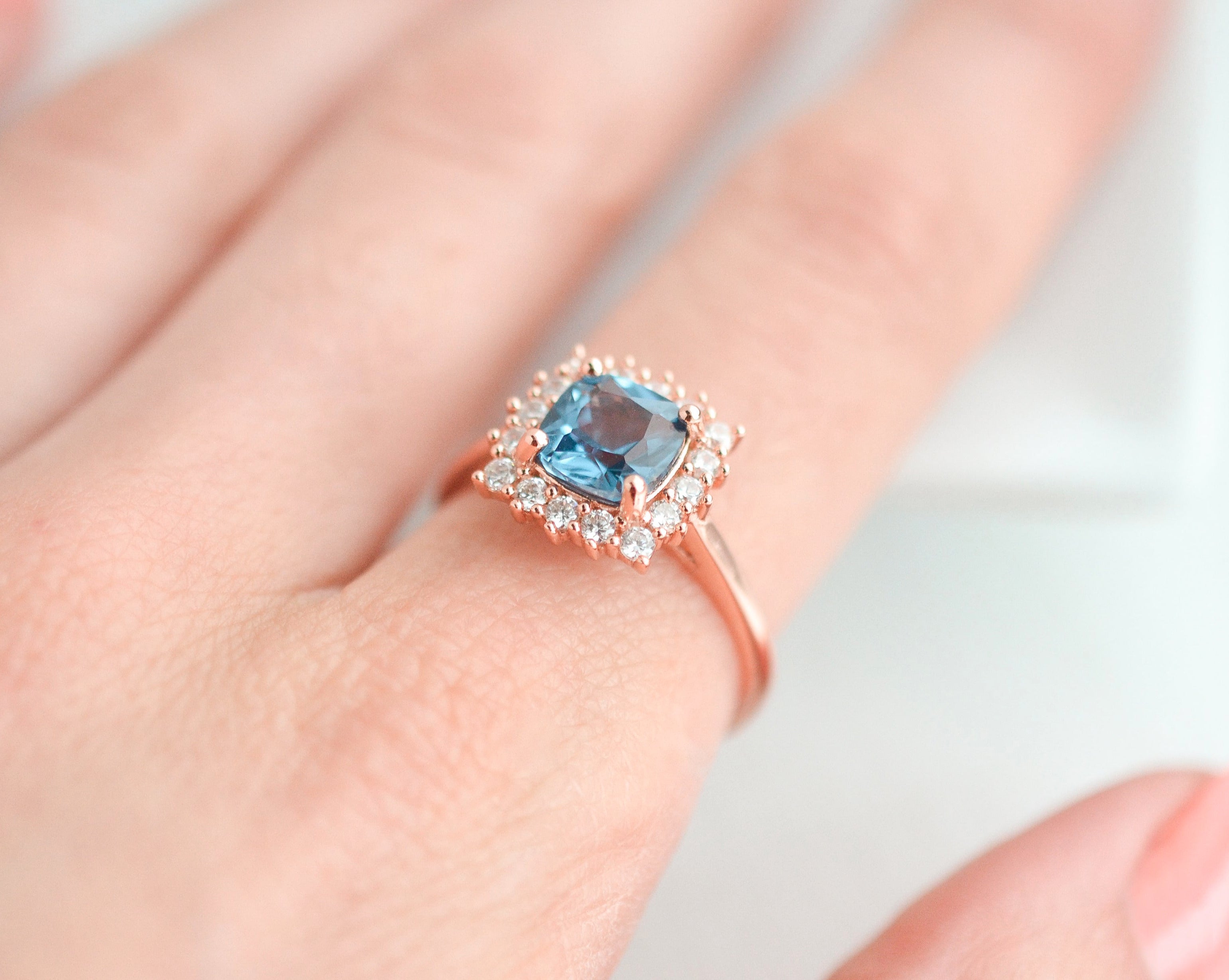 Blue topaz ring in rose gold with CZ accents, gemstone ring