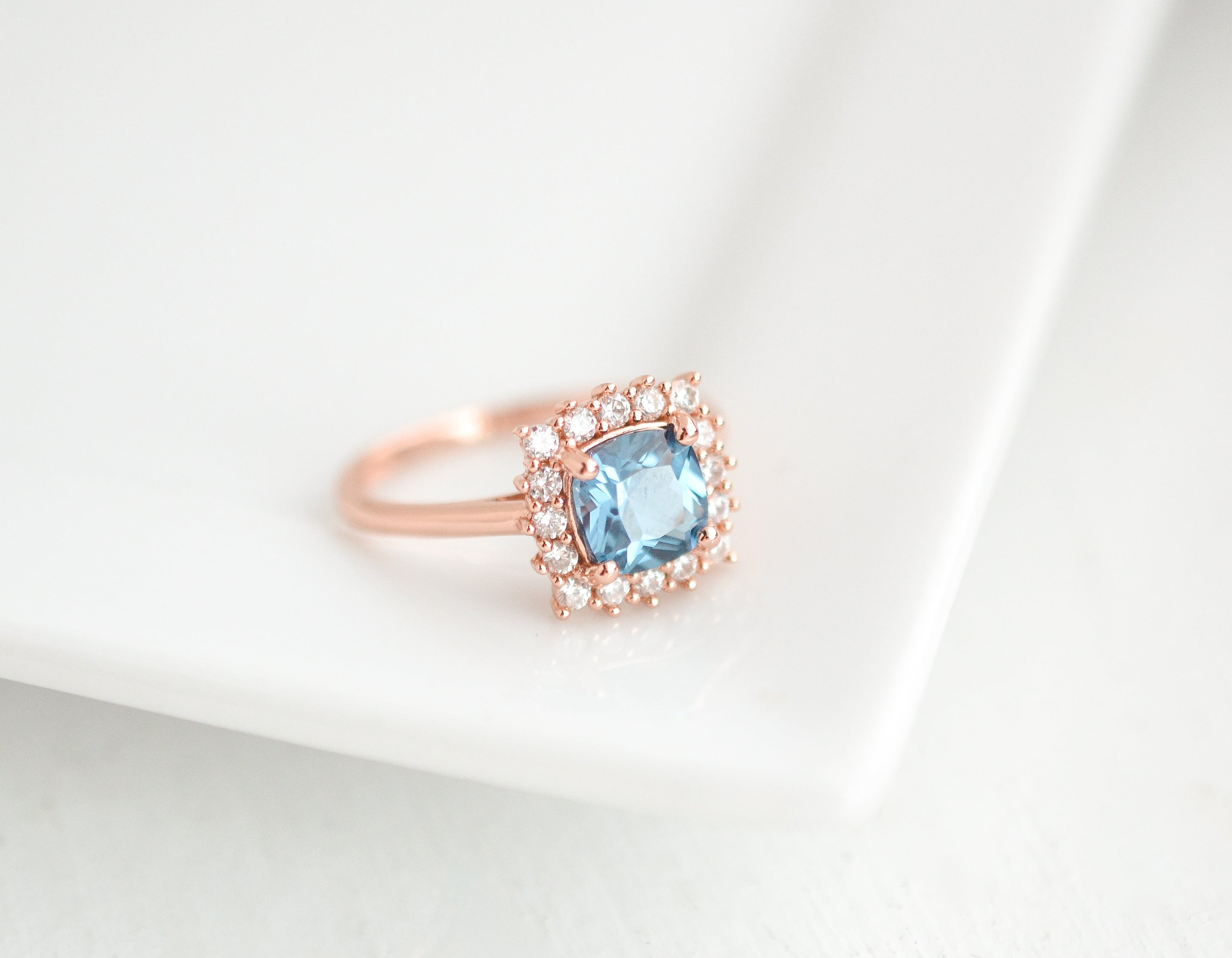 Blue topaz ring in rose gold with CZ accents, gemstone ring