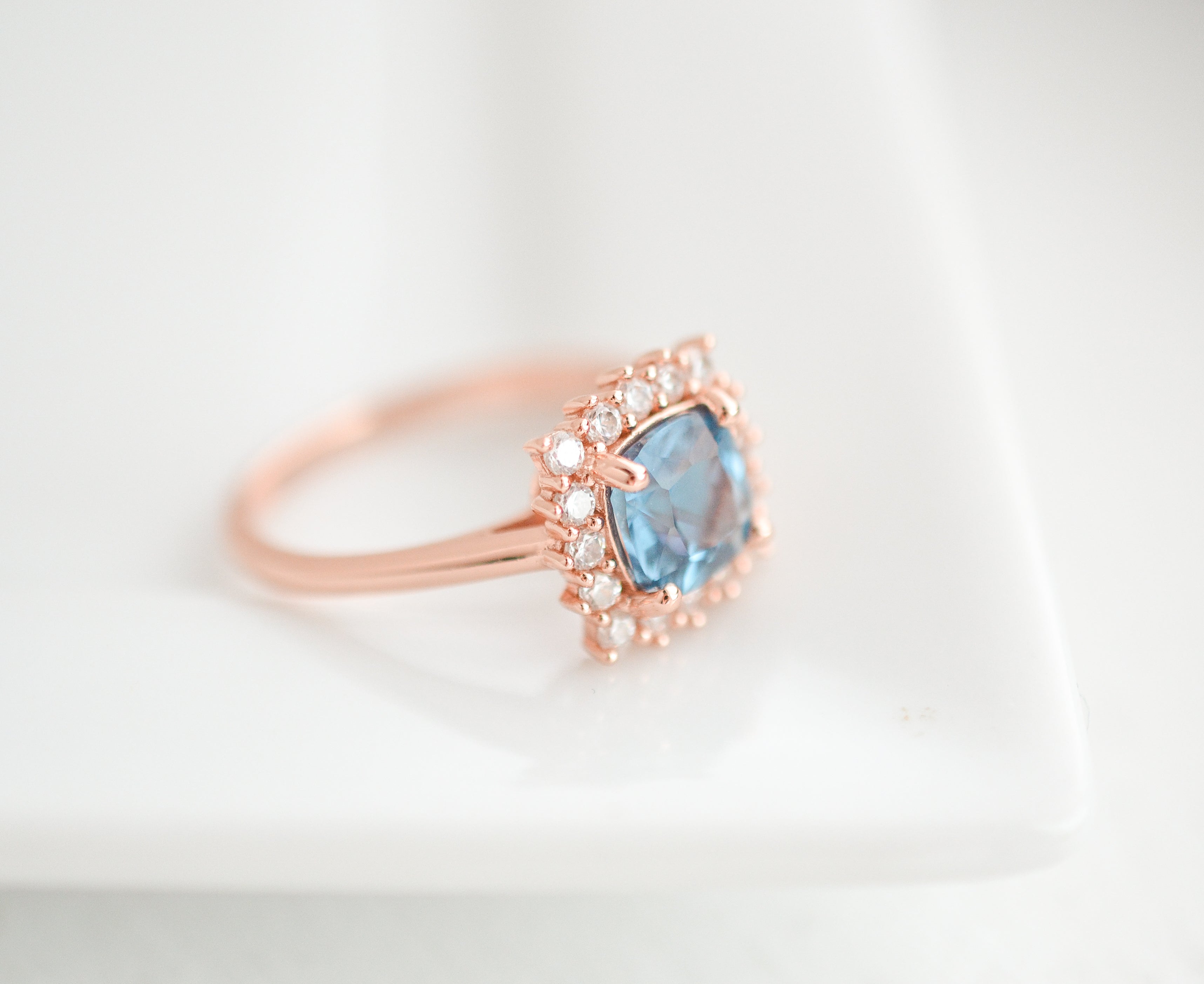 Blue topaz ring in rose gold with CZ accents, gemstone ring