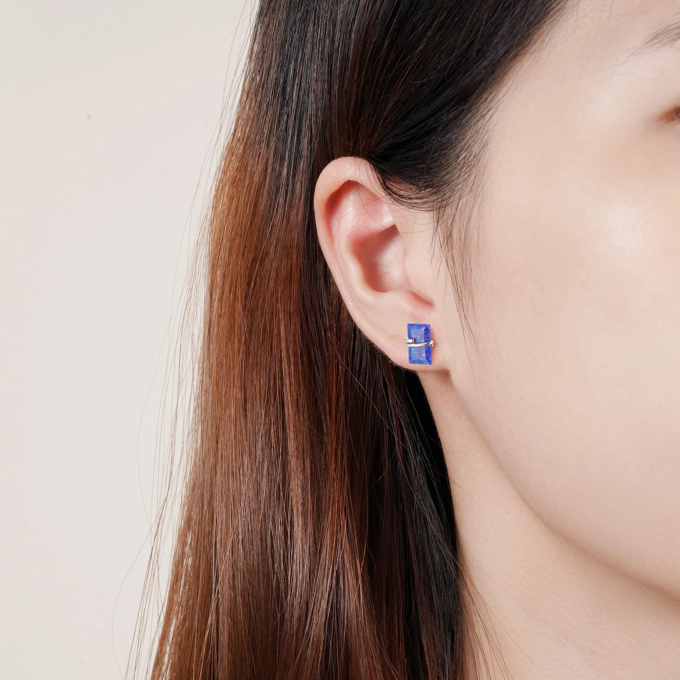 Gabi blue fire opal stud earrings in emerald-cut