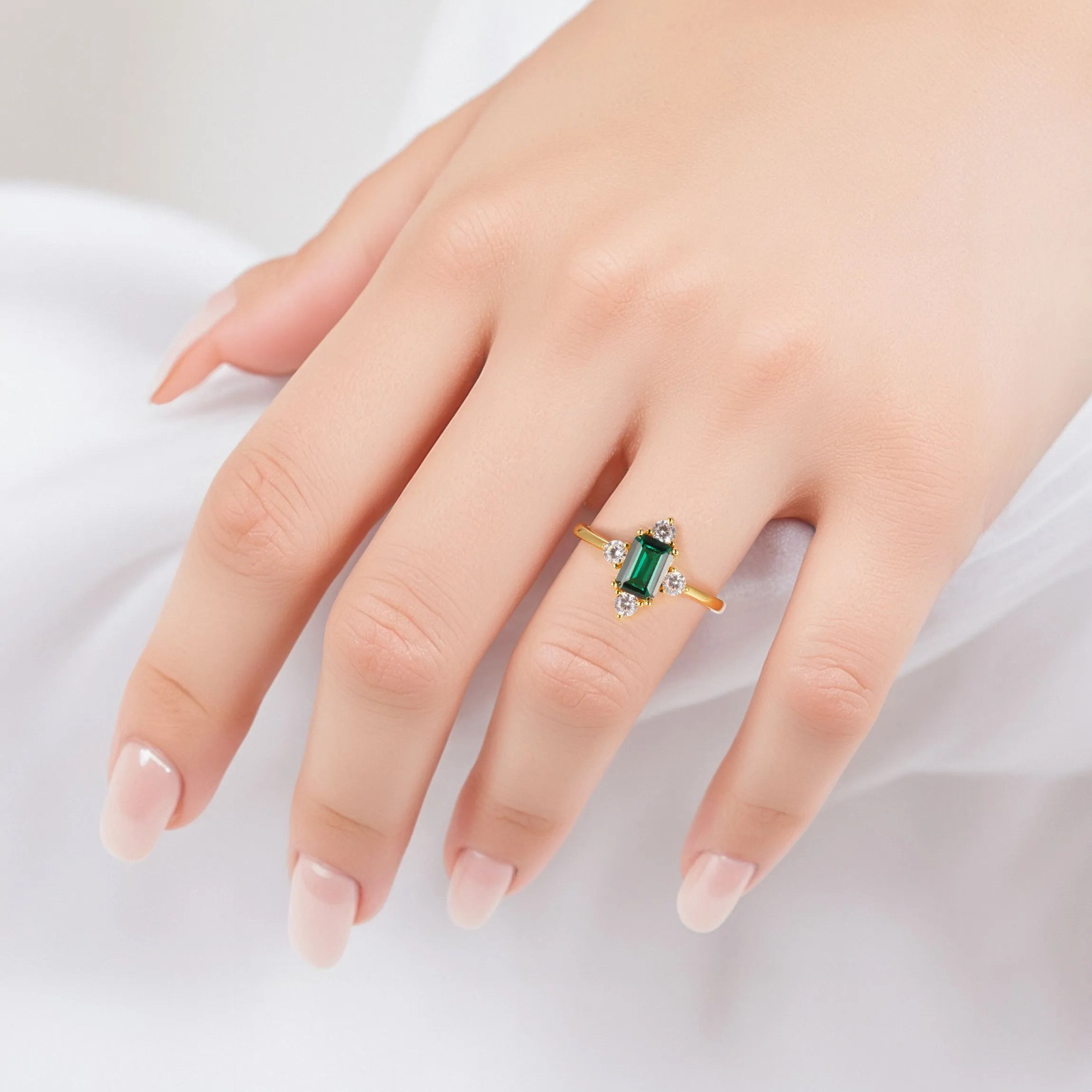 Gold emerald ring with CZ accents and emerald centerpiece