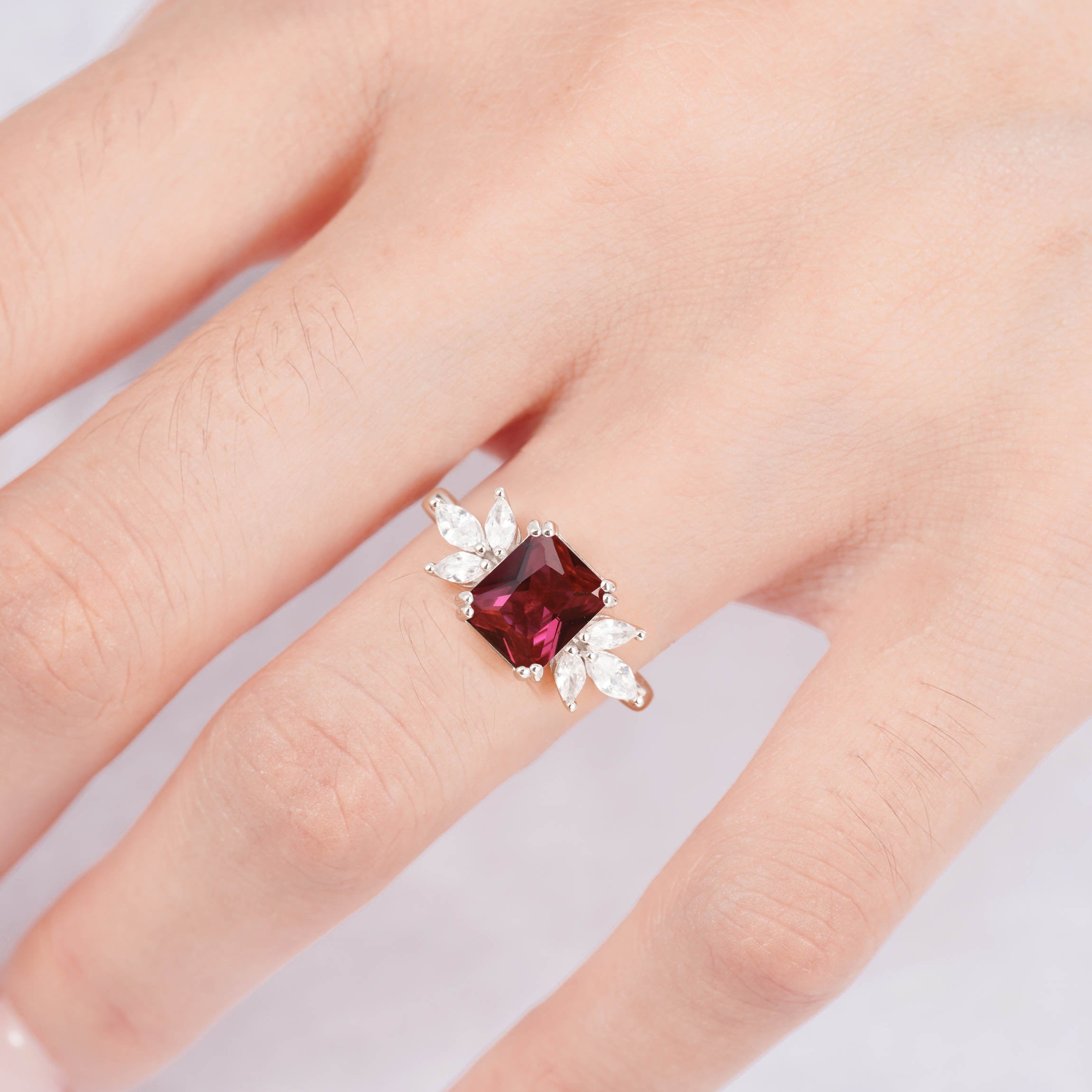 Handcrafted rose gold ruby gemstone ring with CZ crystals.