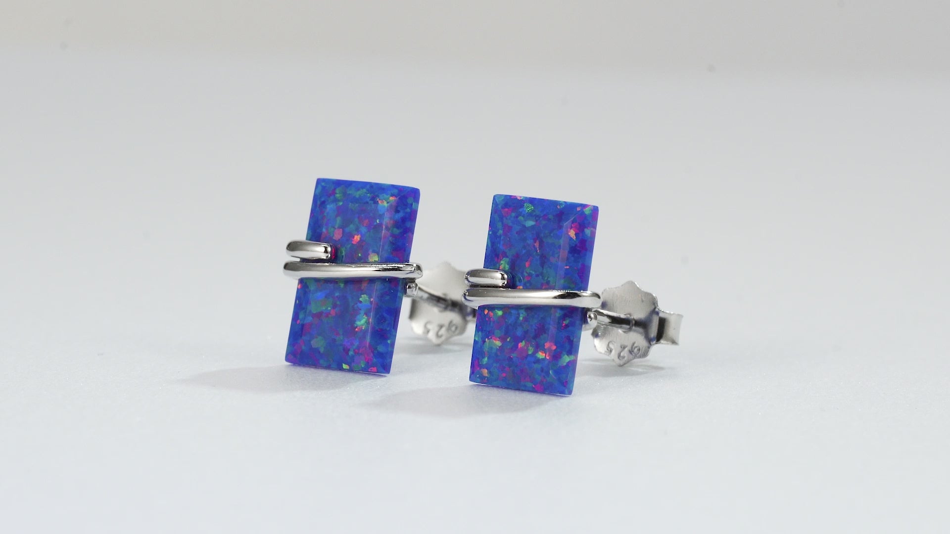 Gabi blue fire opal stud earrings in emerald-cut